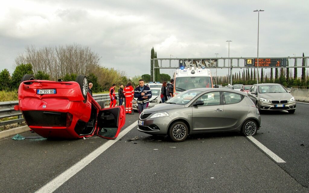red car flipped upside down after car accident - personal injury insurance (PIP)